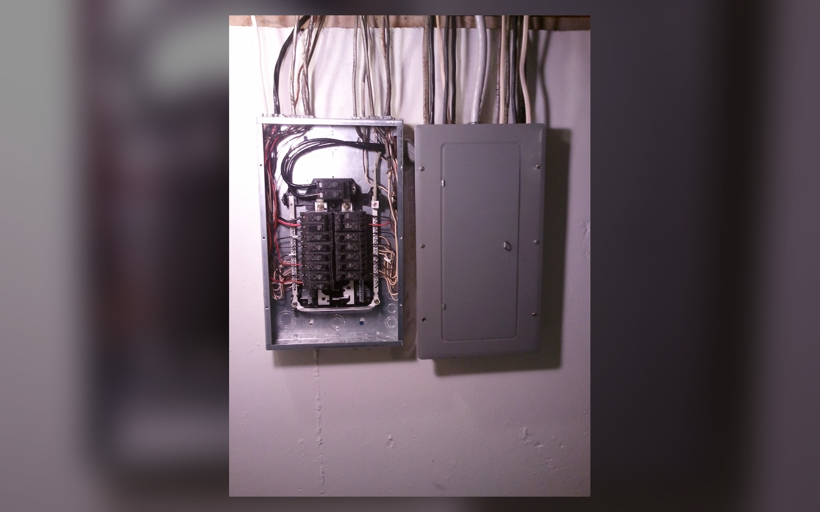 Residential breaker panel and adjacent subpanel opened for a professional inspection