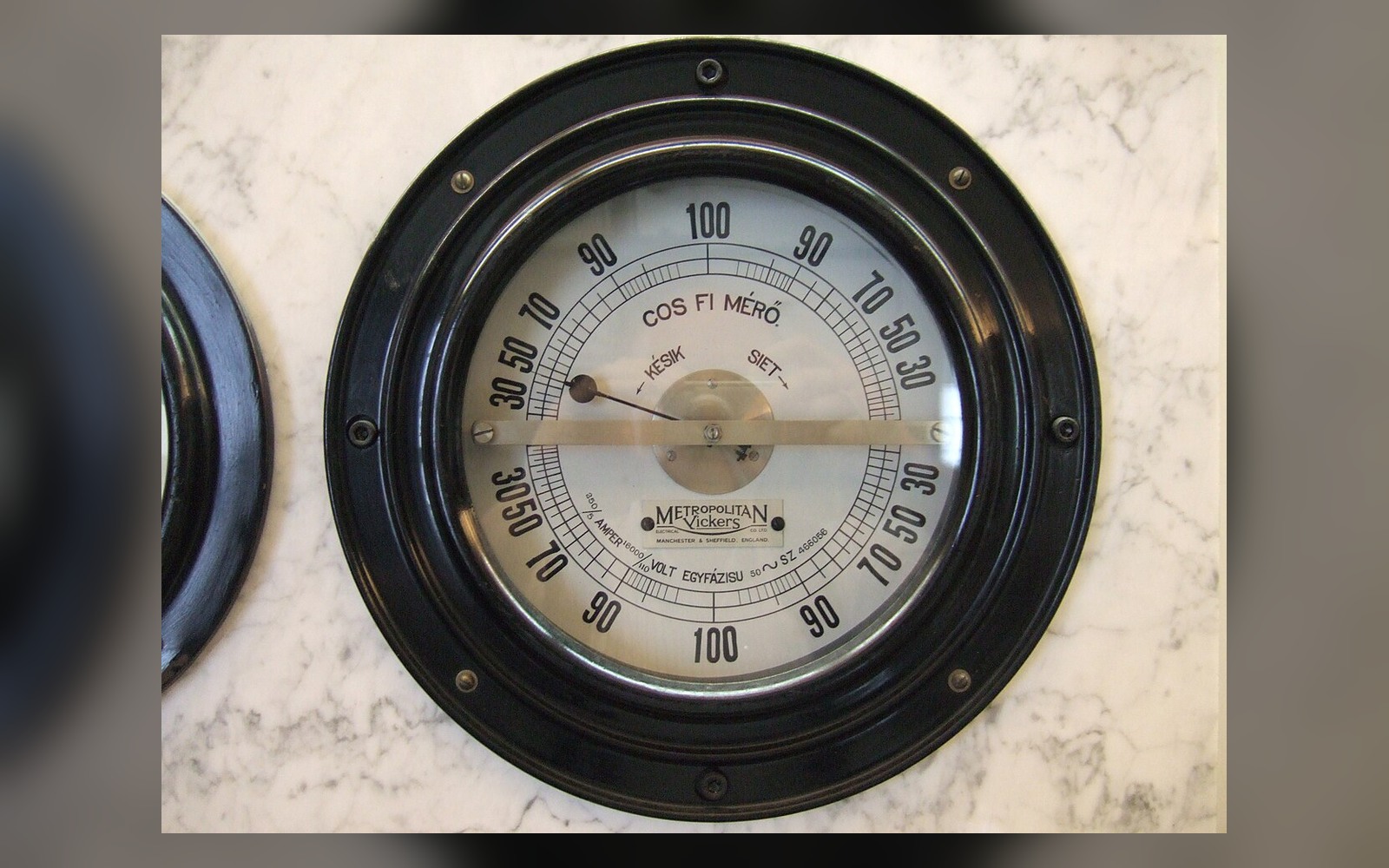 Large analogue power-factor meter illustrating the difference between power measurements
