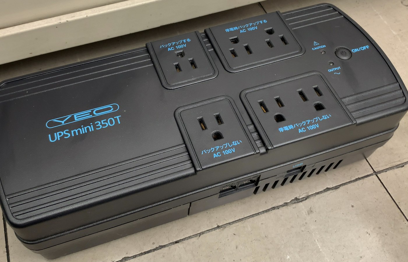 Close view of surge protector or UPS details used to check router continuity and TV and console protection
