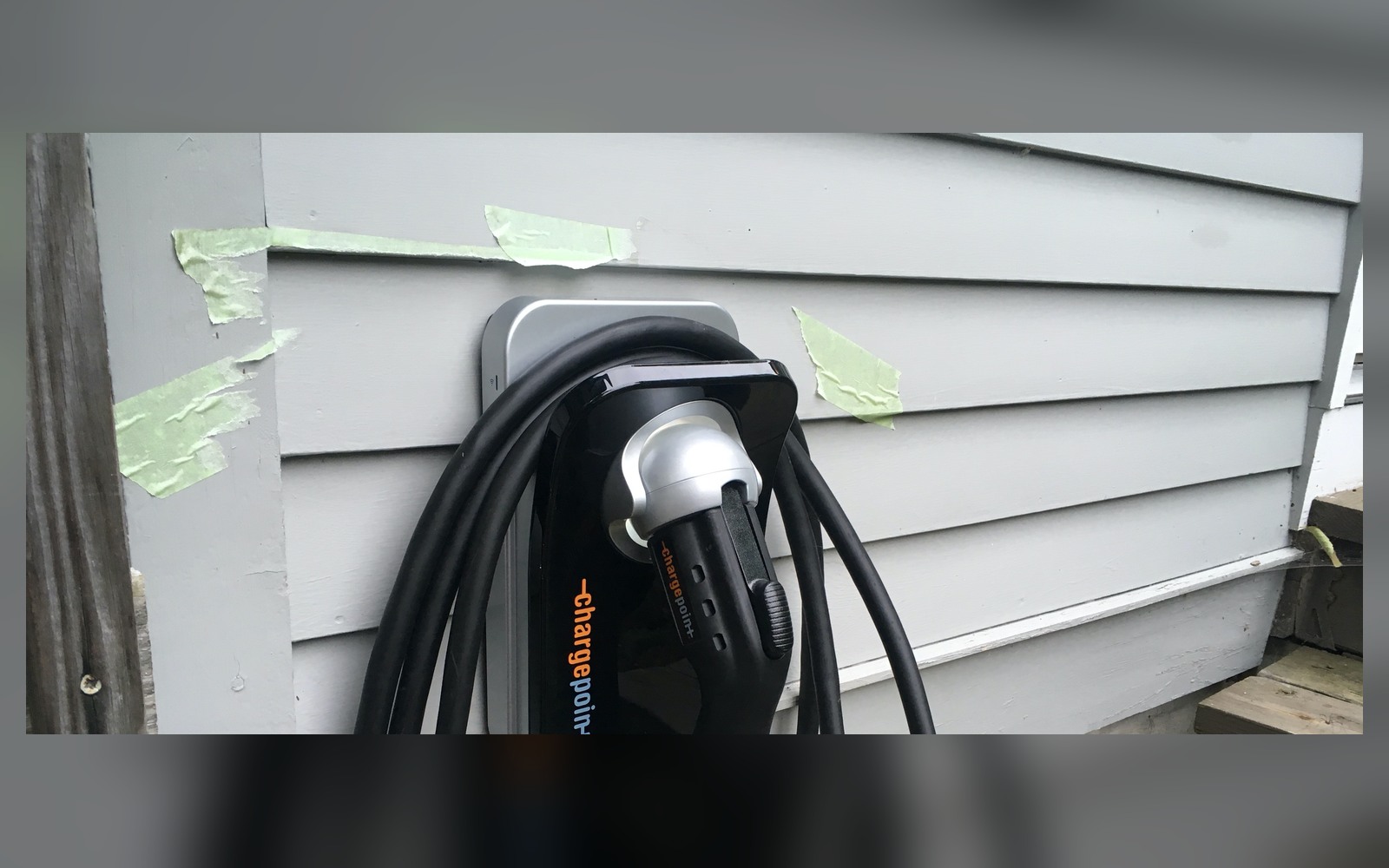 Home electric-vehicle charging point installed beside an exterior wall