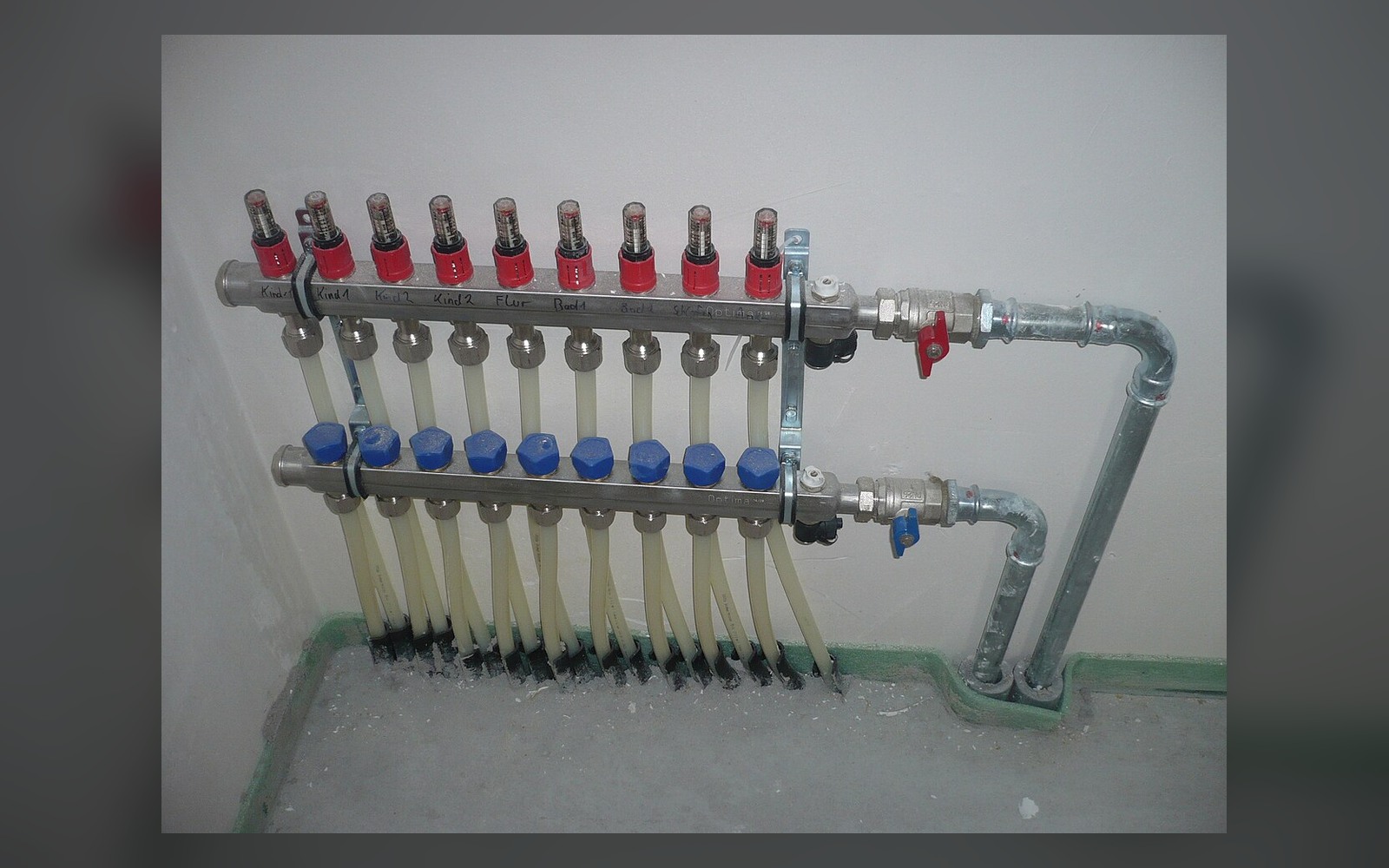 Water-based underfloor-heating manifold with multiple labelled room circuits